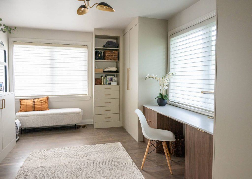 a room with a chair, desk and a window