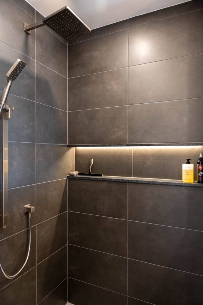 a bathroom with a shower head and a sink