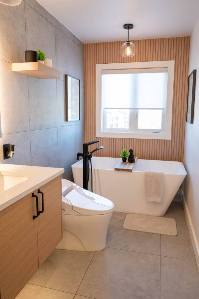 a bath room with a toilet a bath tub and a window