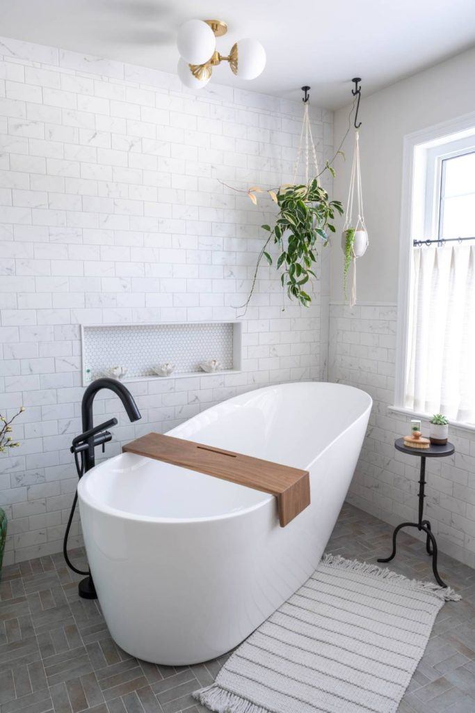 a white bath tub sitting next to a window