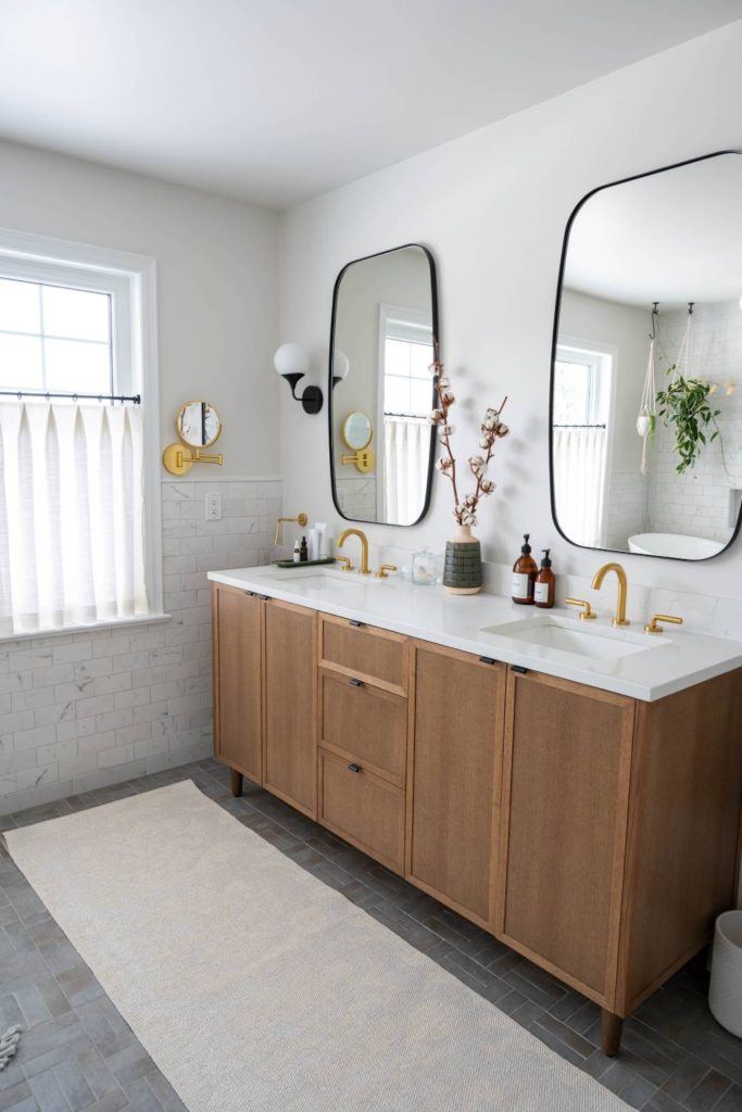 a bathroom with two mirrors and a sink